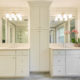 Master bathroom remodel with his and hers separate white vanities, quartz counters, linen cabinet with white crown molding in Morristown, NJ renovated by JMC Home Improvement Specialists