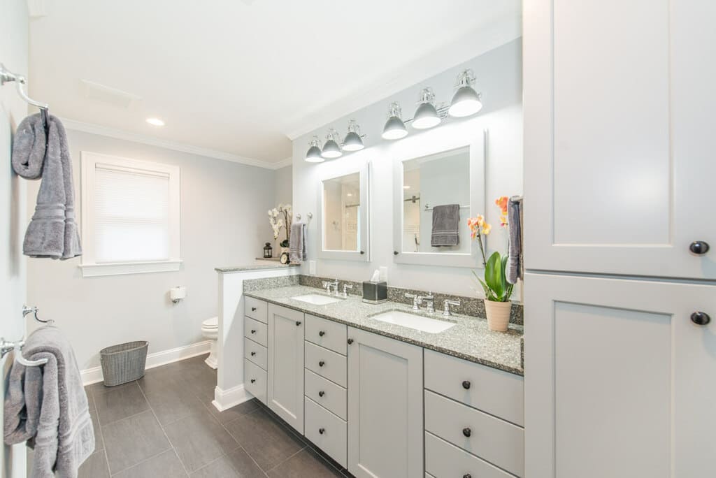 Grey and white bathroom remodel with dual undermount sink vanity with shaker cabinets, white wood framed mirrors in Randolph, NJ renovated by JMC Home Improvement Specialists