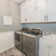 White and grey laundry room remodel with shaker cabinets with crown molding with slop sink in Florham Park, NJ renovated by JMC Home Improvement Specialists
