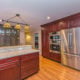 Cherry kitchen cabinets with green accent, and granite counters double oven, crown molding and hardwood flooring in Morris Plains, NJ renovated by JMC Home Improvement Specialists
