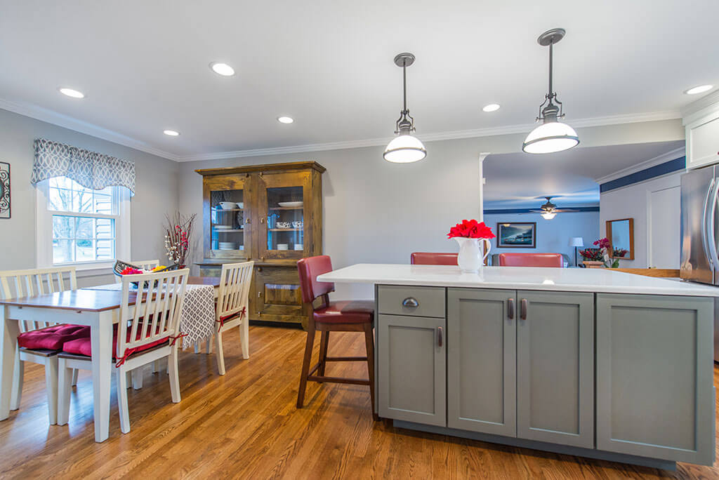 White and Grey two tone kitchen remodel with hardwood flooring, quartz counters, pendant lighting over island in Parsippany, NJ remodeled by JMC Home Improvement Specialists