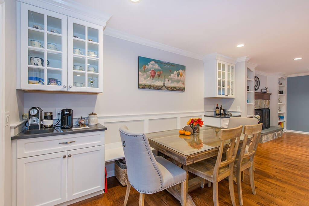 Kitchen remodel with table for dining, coffee station with white shaker lower cabinets and glass upper cabinets in Randolph, NJ remodeled by JMC Home Improvement Specialists