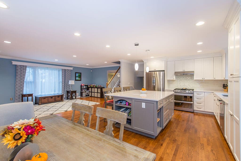 Open concept kitchen with flush header, white shaker cabinets and grey island with quartz counter in Randolph, NJ remodeled by JMC Home Improvement Specialists