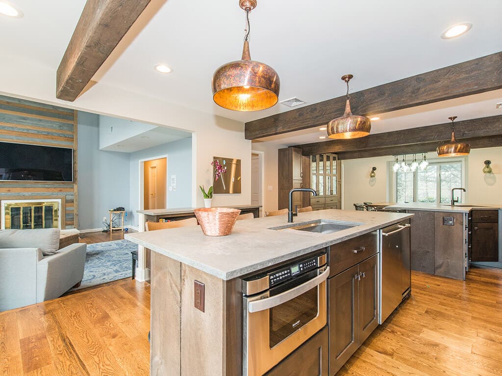 Open floor plan industrial kitchen with wood beams, concrete countertop in Rockaway, NJ remodeled by JMC Home Improvement Specialists