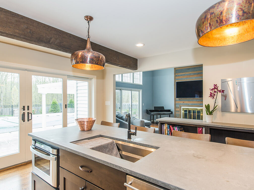 Rustic Open floor plan industrial kitchen, wood beams, concrete countertop with undermount sink in Rockaway, NJ remodeled by JMC Home Improvement Specialists