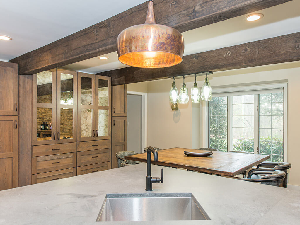 Rustic Open floor plan industrial kitchen, wood shaker cabinets with mirror doors, wood beams, concrete countertop with bar sink in Rockaway, NJ remodeled by JMC Home Improvement Specialists