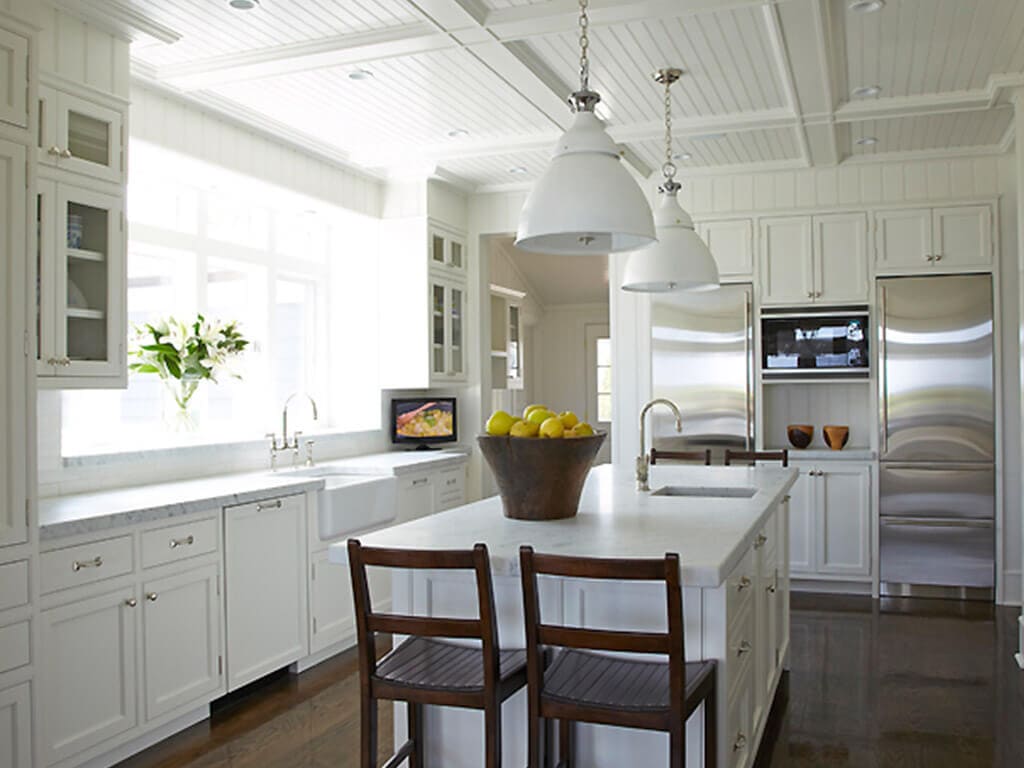 White kitchen with shaker double stack cabinets with Carrera marble with bar sink, built in refrigerator, apron sink in Springlake, NJ remodeled by JMC Home Improvement Specialists