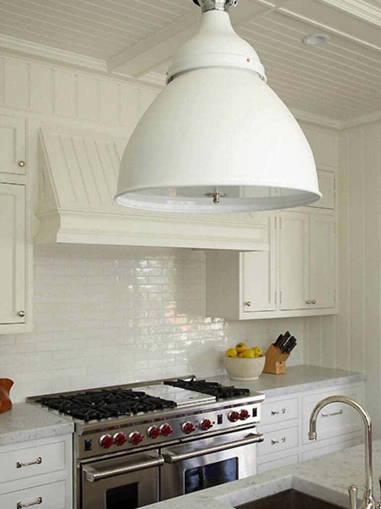 White kitchen with beadboard, custom wood hood, Carrera marble, white subway tile backsplash, in Springlake, NJ remodeled by JMC Home Improvement Specialists