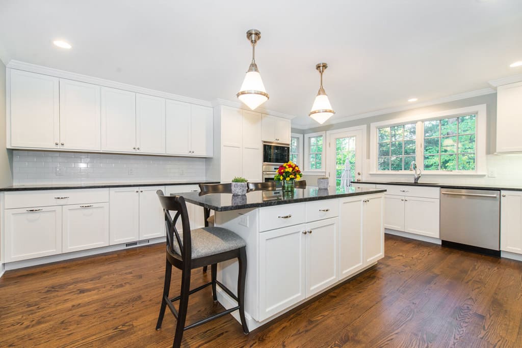 White kitchen with shaker cabinets, subway tile backsplash, black pearl granite countertops in Springfield, NJ remodeled by JMC Home Improvement Specialists