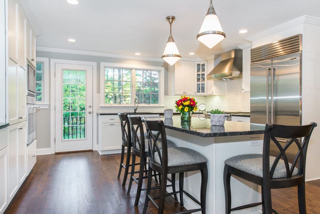 White kitchen with shaker cabinets, subway tile backsplash, black pearl granite countertops in Morris County, NJ remodeled by JMC Home Improvement Specialists