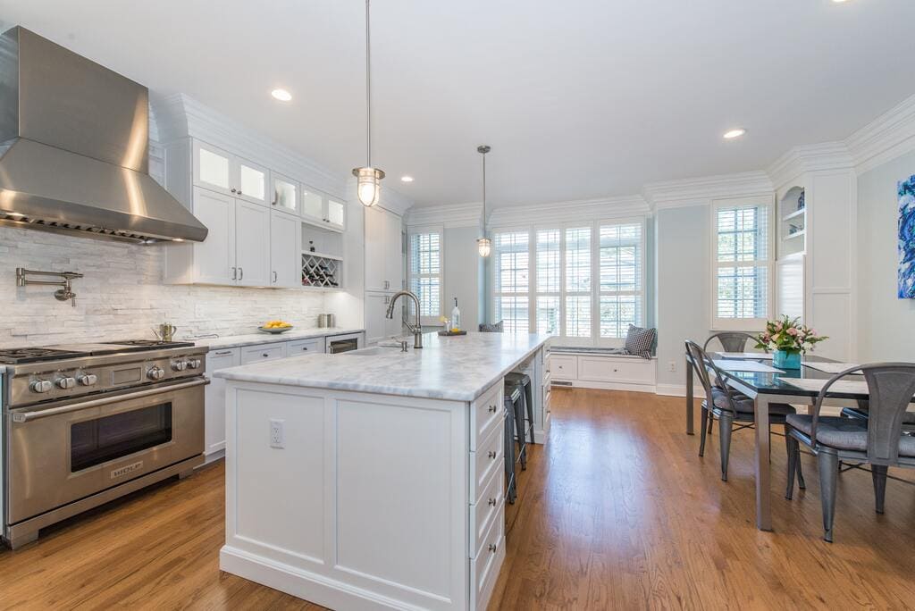 White kitchen with metal freestanding hood and pot filler in Morristown, NJ remodeled by JMC Home Improvement Specialists