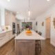 Two tone kitchen with drift wood accent island with pendants and farmhouse sink in Randolph, NJ renovated by JMC Home Improvement Specialists