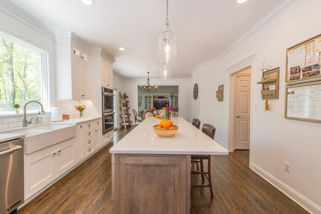 Two tone kitchen with drift wood accent island with pendants and farmhouse sink in Randolph, NJ renovated by JMC Home Improvement Specialists