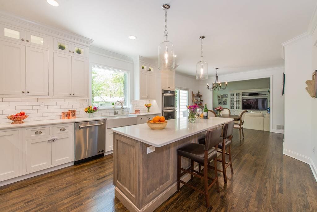 White kitchen cabinets with subway tile backsplash and hardwood flooring in Randolph, NJ remodeled by JMC Home Improvement Specialists