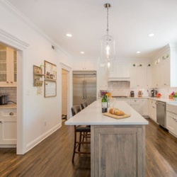 A White Kitchen with Drift Wood Accent Island in Randolph