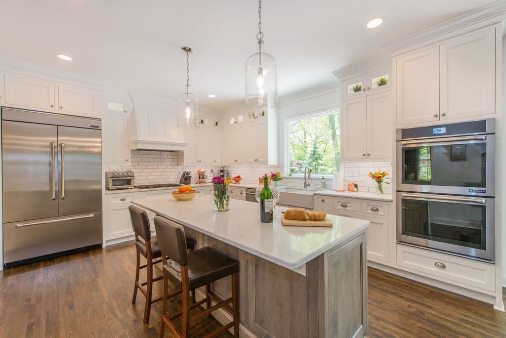 White shaker kitchen cabinets with cup pulls, driftwood accent island and custom wood hood in Randolph, NJ remodeled by JMC Home Improvement Specialists