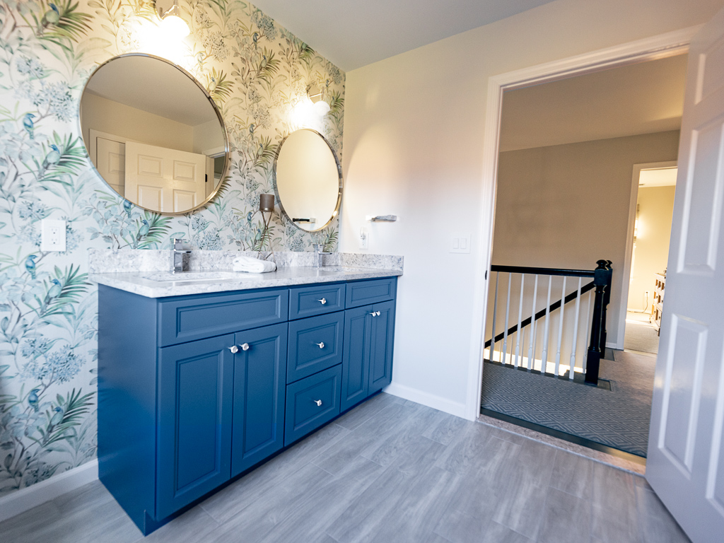 Modern Main Bath with Shower and window with blue cabinets bathroom remodel renovated by JMC Home Improvement Specialists