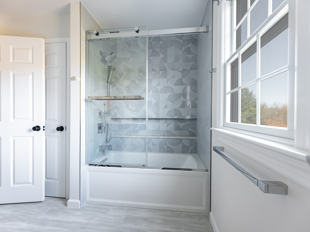 Modern Main Bath with Shower and window with blue cabinets bathroom remodel renovated by JMC Home Improvement Specialists