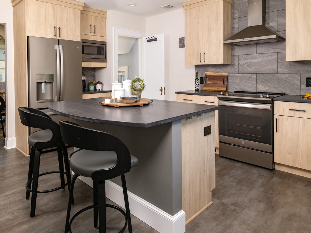 Kitchen remodel with large tile backspalsh, Vinyl flooring, black island,  flat panel cabinets, large walk-in pantry in Morris Plains, NJ remodeled by JMC Home Improvement Specialists