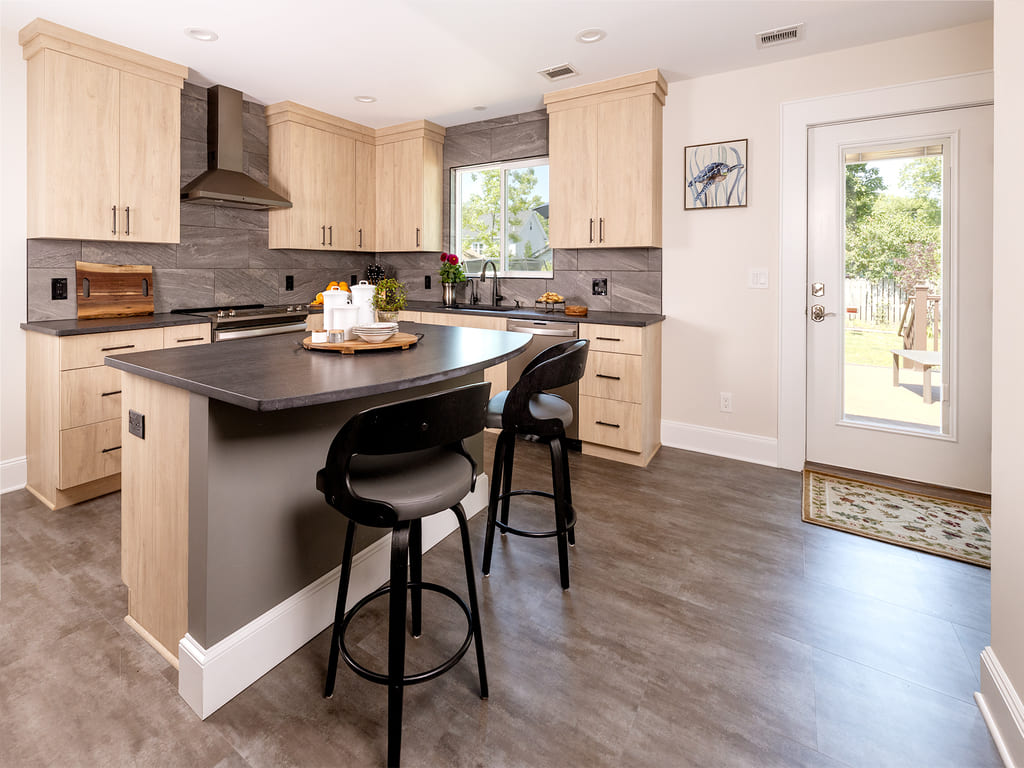 Kitchen remodel with large tile backspalsh, Vinyl flooring, black island,  flat panel cabinets, large walk-in pantry in Morris Plains, NJ remodeled by JMC Home Improvement Specialists