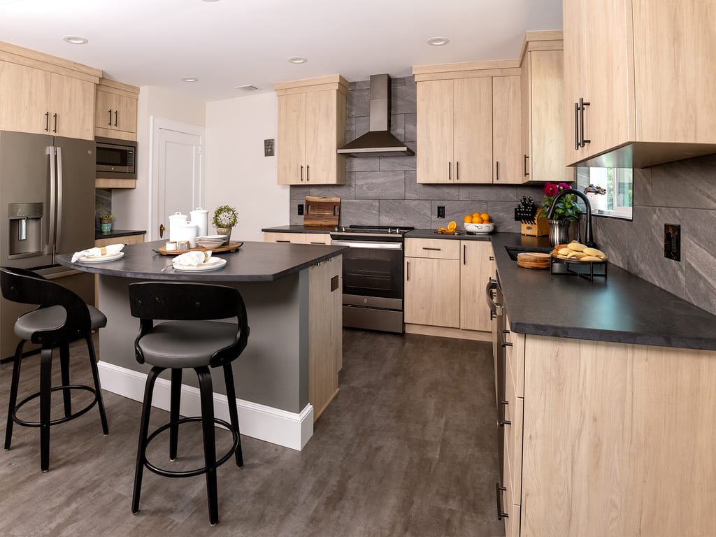 Kitchen remodel with large tile backspalsh, Vinyl flooring, black island,  flat panel cabinets, large walk-in pantry in Morris Plains, NJ remodeled by JMC Home Improvement Specialists