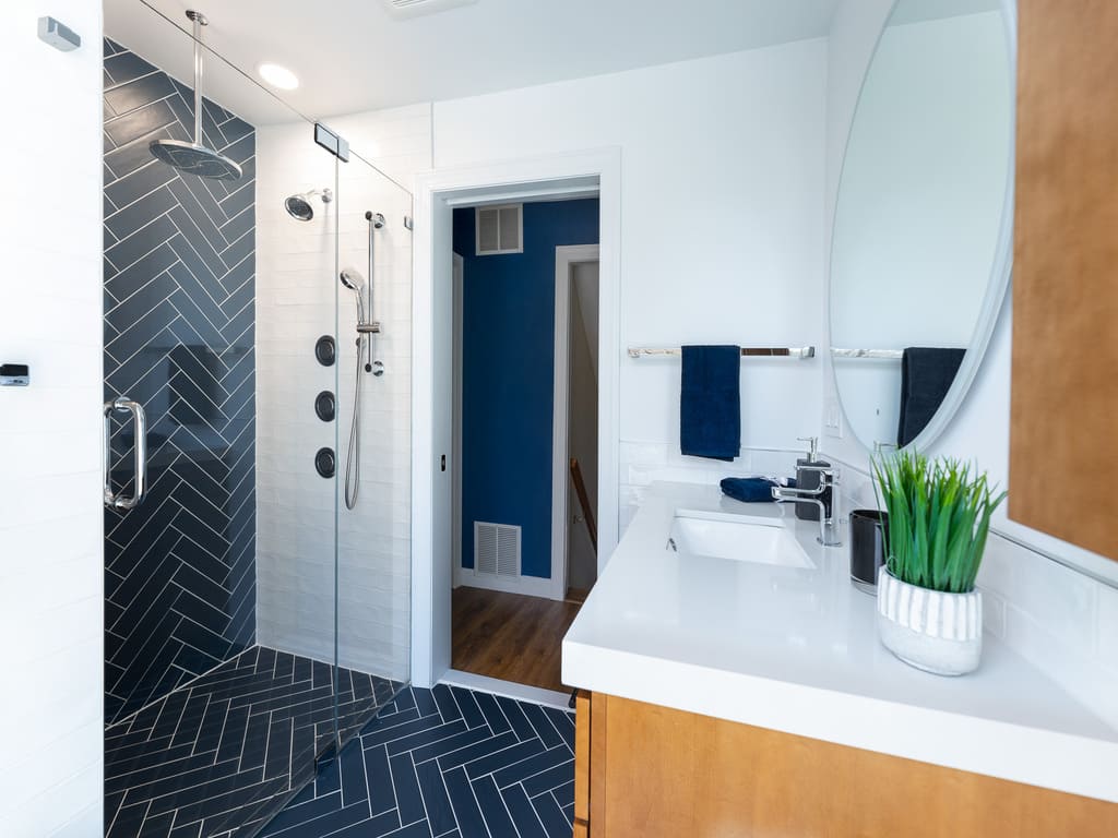 Blue chevron shower tile in bathroom remodel in Byram NJ renovated by JMC Home Improvement Specialists 