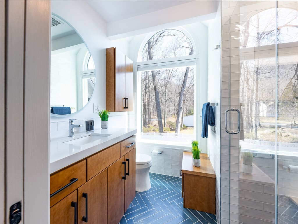 Blue chevron shower tile in bathroom remodel in Byram NJ renovated by JMC Home Improvement Specialists 