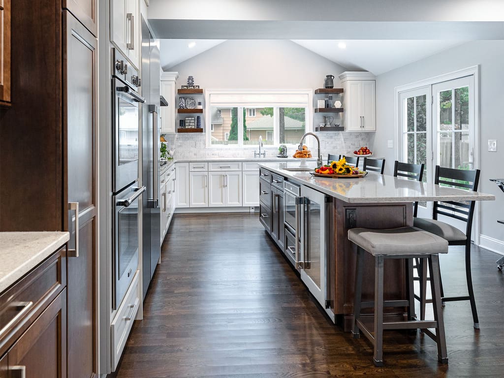 Two-tone kitchen remodel with cooktop, microwave drawer, double oven, kitchen island with prep sink in West Caldwell, NJ renovated by JMC Home Improvement Specialists