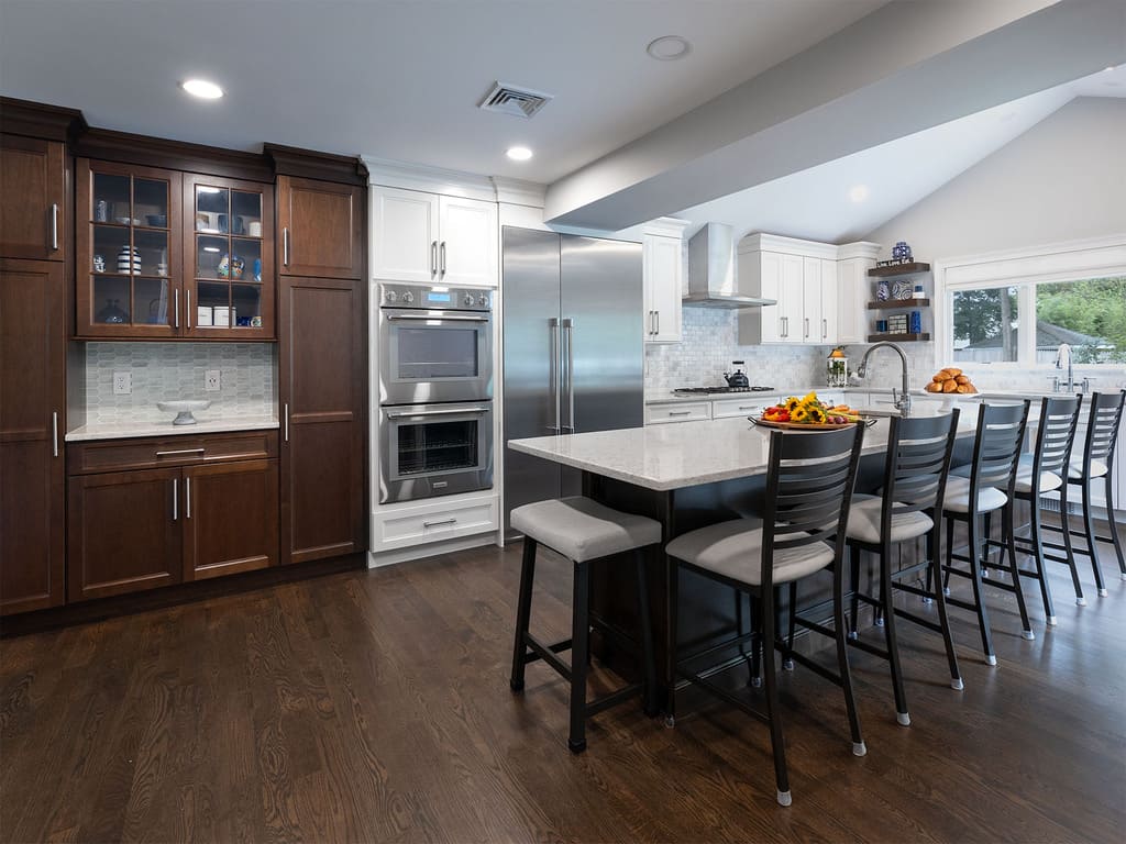 Two-tone kitchen remodel with cooktop, microwave drawer, double oven, kitchen island with prep sink in West Caldwell, NJ renovated by JMC Home Improvement Specialists