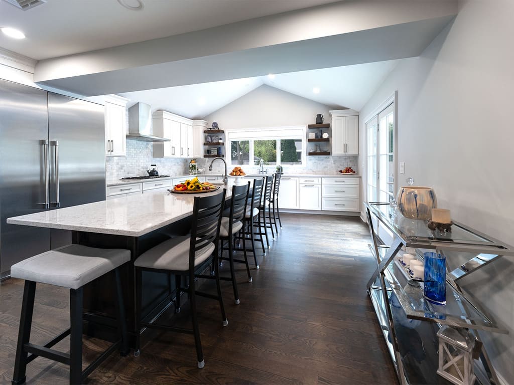 Two-tone kitchen remodel with cooktop, microwave drawer, double oven, kitchen island with prep sink in West Caldwell, NJ renovated by JMC Home Improvement Specialists