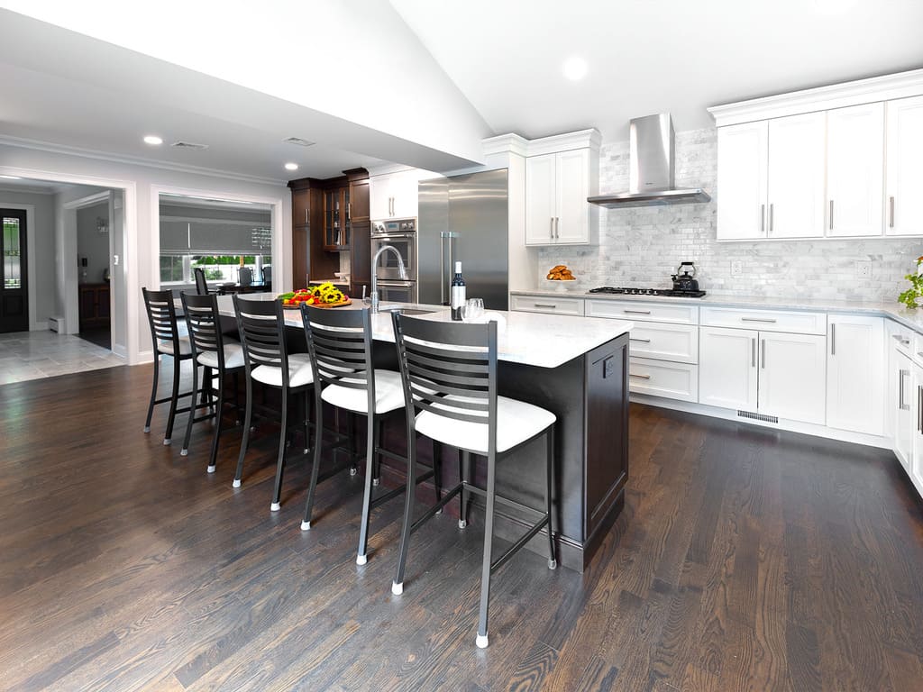 Two-tone kitchen remodel with cooktop, microwave drawer, double oven, kitchen island with prep sink in West Caldwell, NJ renovated by JMC Home Improvement Specialists