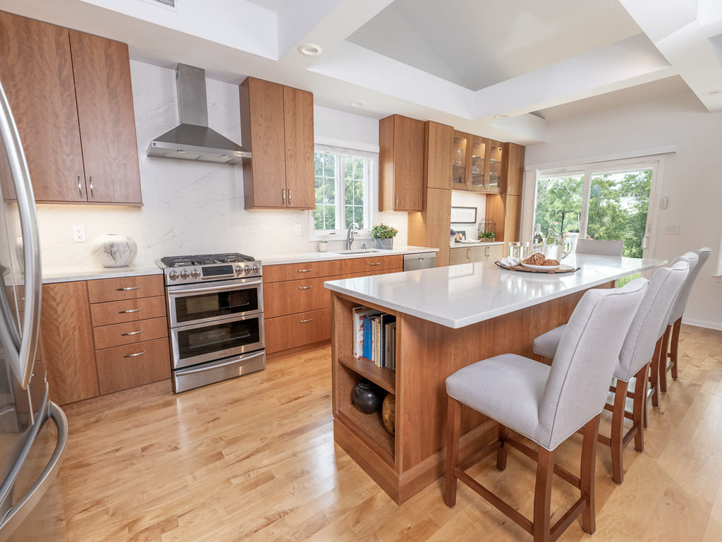 Open kitchen with glass cabinets, kitchen island, flat panel cabinets, open bookcase, custom ceiling beams in Somerset, NJ renovated by JMC Home Improvement Specialists