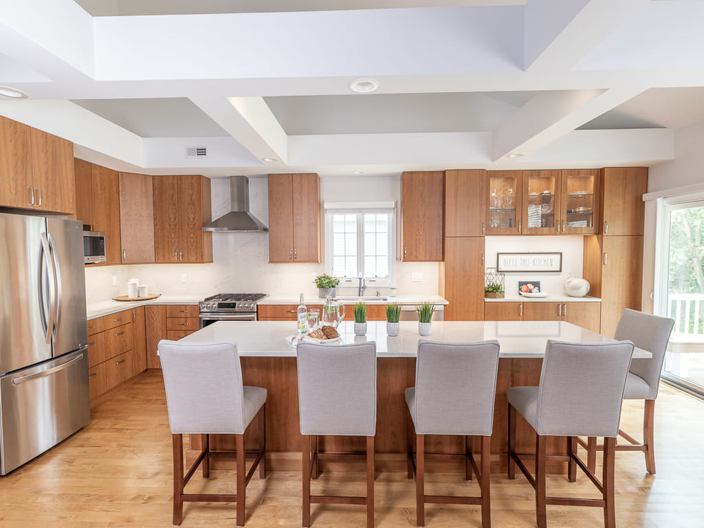 Open kitchen with glass cabinets, kitchen island, flat panel cabinets, open bookcase, custom ceiling beams in Somerset, NJ renovated by JMC Home Improvement Specialists