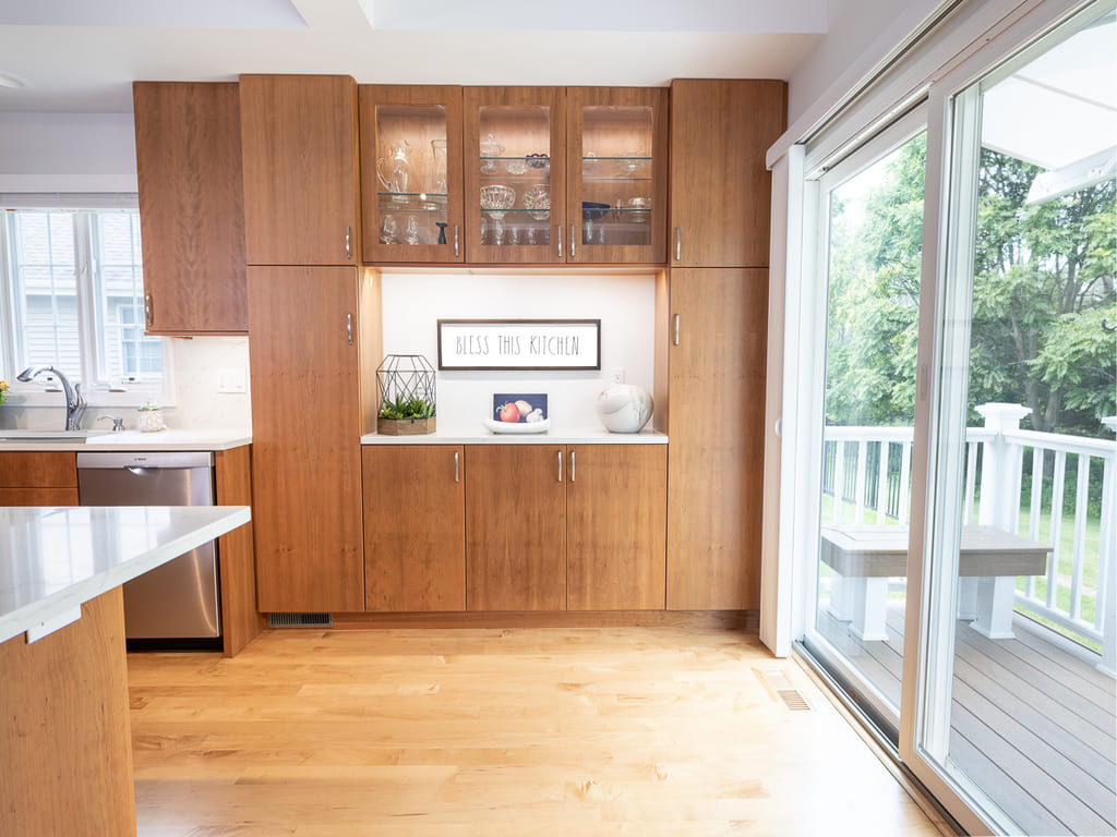 Open kitchen with glass cabinets, kitchen island, flat panel cabinets, open bookcase, custom ceiling beams in Somerset, NJ renovated by JMC Home Improvement Specialists