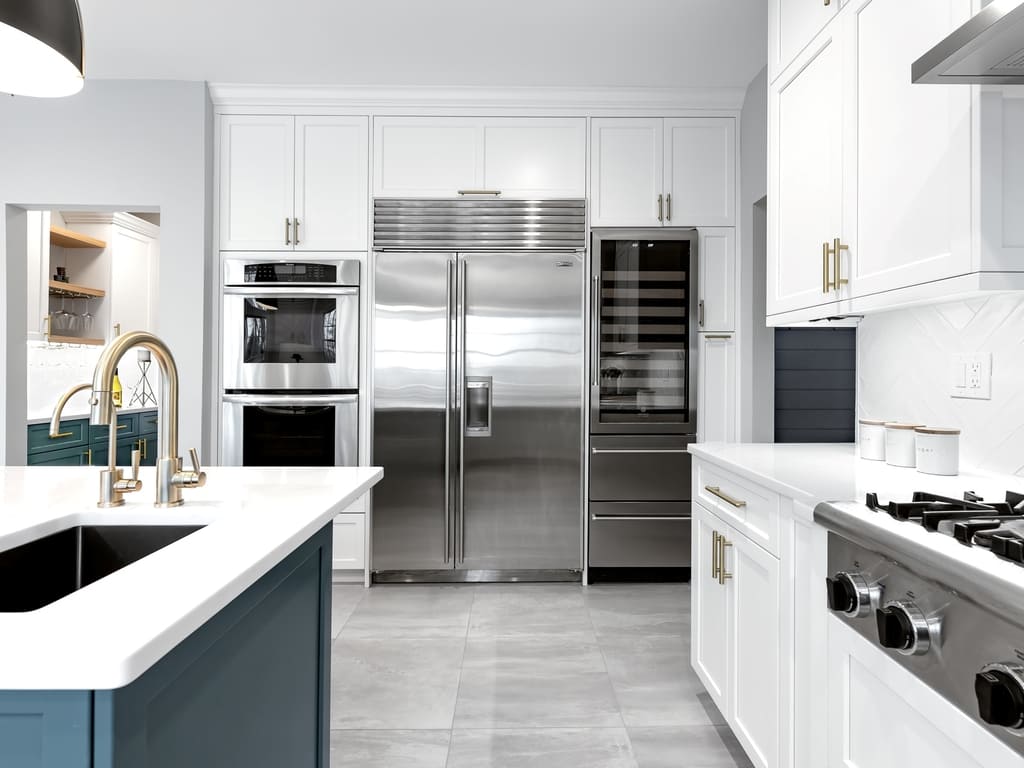 Two tone modern kitchen remodel with brushed gold accents in Towaco, NJ renovated by JMC Home Improvement Specialists