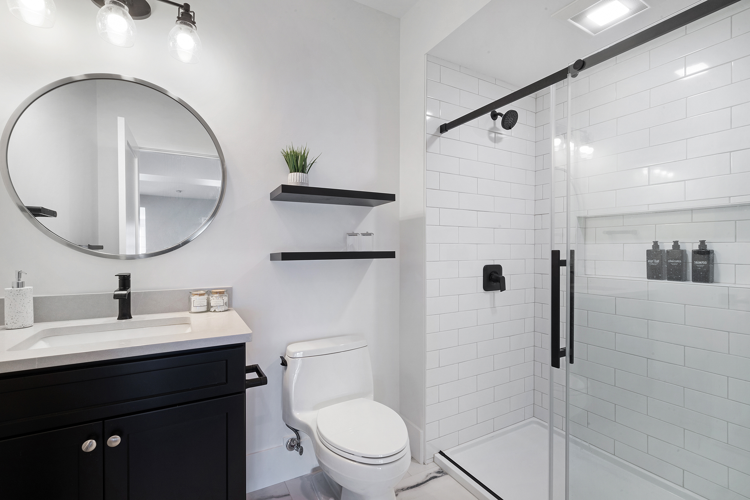 Basement and Bathroom remodel with matte black, barn door slider, shaker style door, polished ceramic subway tile in Cedar Grove, NJ renovated by JMC Home Improvement Specialists