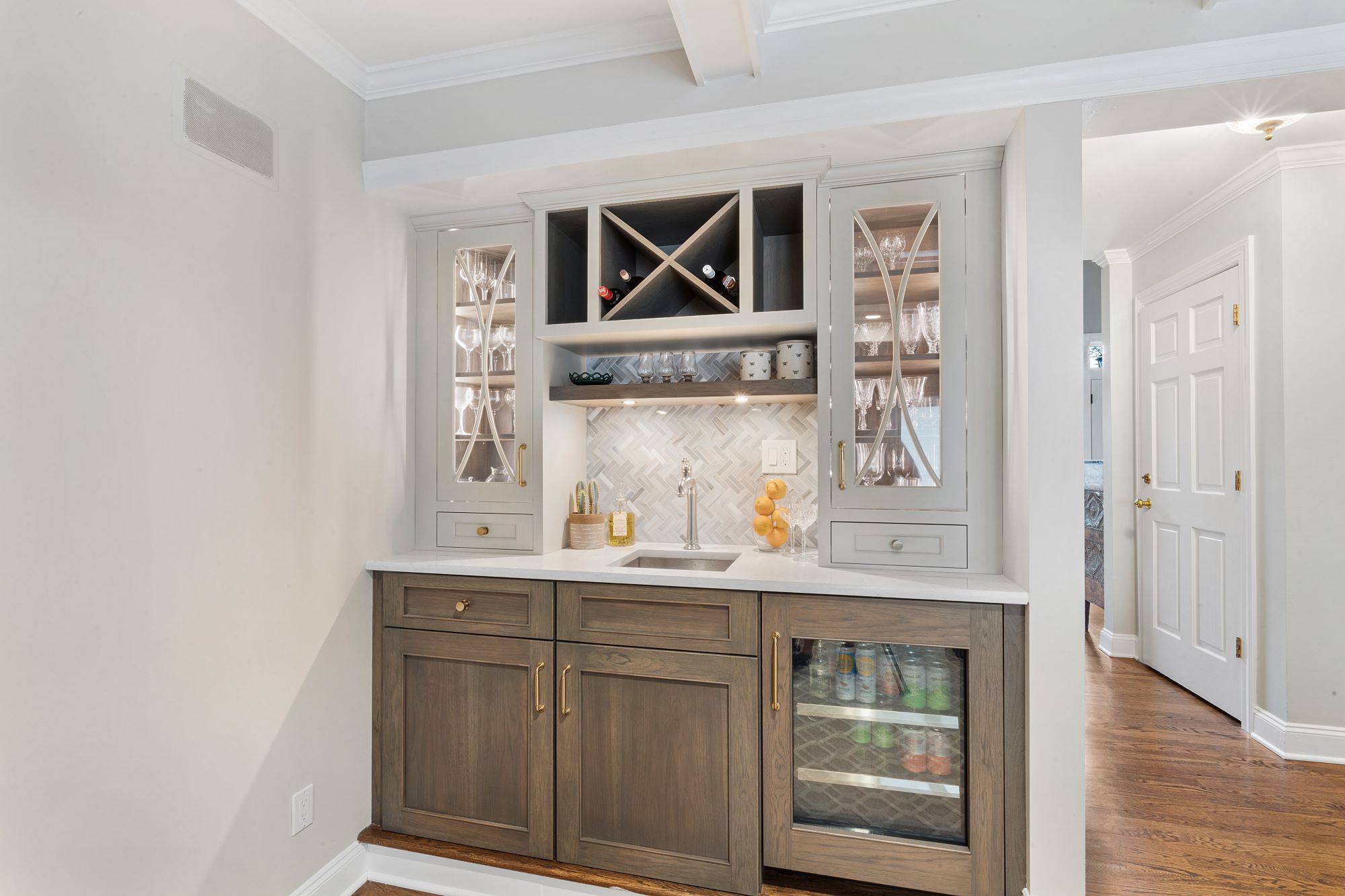 Wetbar with glass cabinets and wine and liquor storage gray color and tile backsplash in North Caldwell, NJ