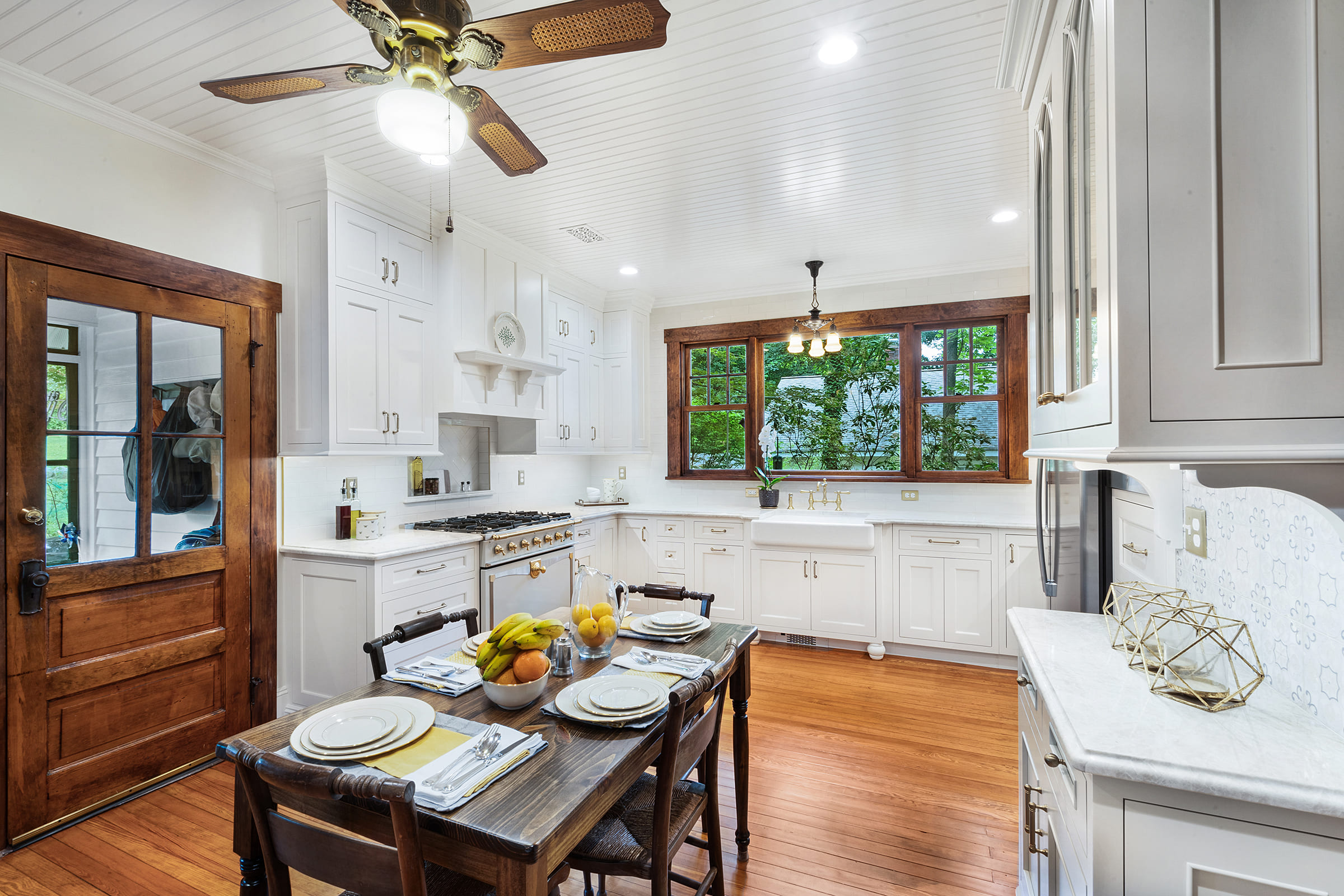 U shaped kitchen remodel with maple painted cabinets in snail and TC Platinum, gold faucets, honey bronze pulls and refinished wood floors remodeled in Butler, NJ by JMC Home Improvement Specialists