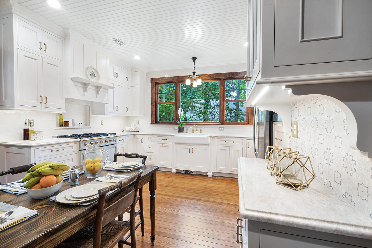 U shaped kitchen remodel with maple painted cabinets in snail and TC Platinum, gold faucets, honey bronze pulls and refinished wood floors remodeled in Butler, NJ by JMC Home Improvement Specialists