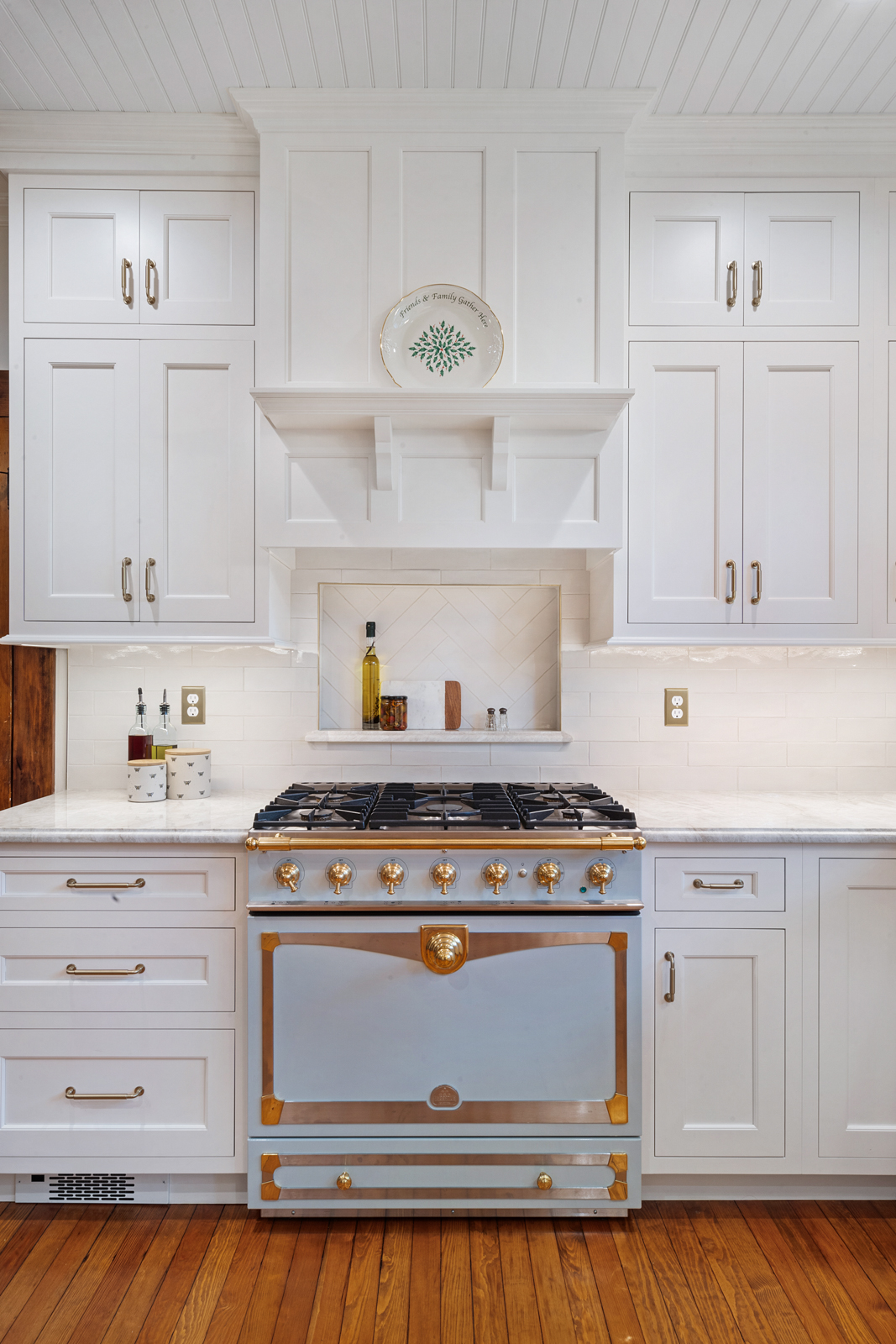 U shaped kitchen remodel with maple painted cabinets in snail and TC Platinum, gold faucets, honey bronze pulls and refinished wood floors remodeled in Butler, NJ by JMC Home Improvement Specialists