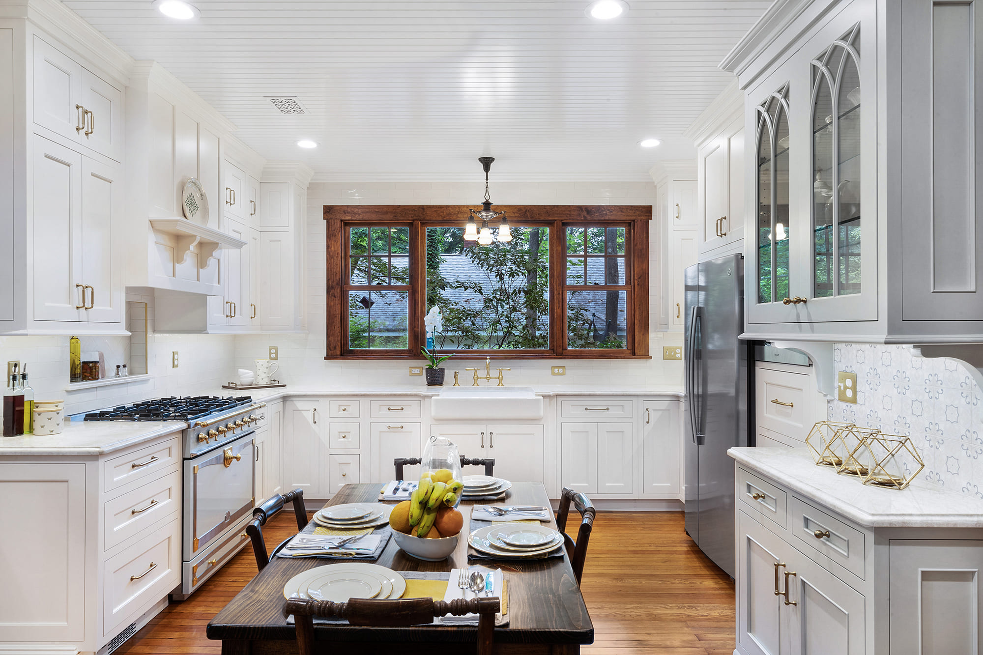 U shaped kitchen remodel with maple painted cabinets in snail and TC Platinum, gold faucets, honey bronze pulls and refinished wood floors remodeled in Butler, NJ by JMC Home Improvement Specialists