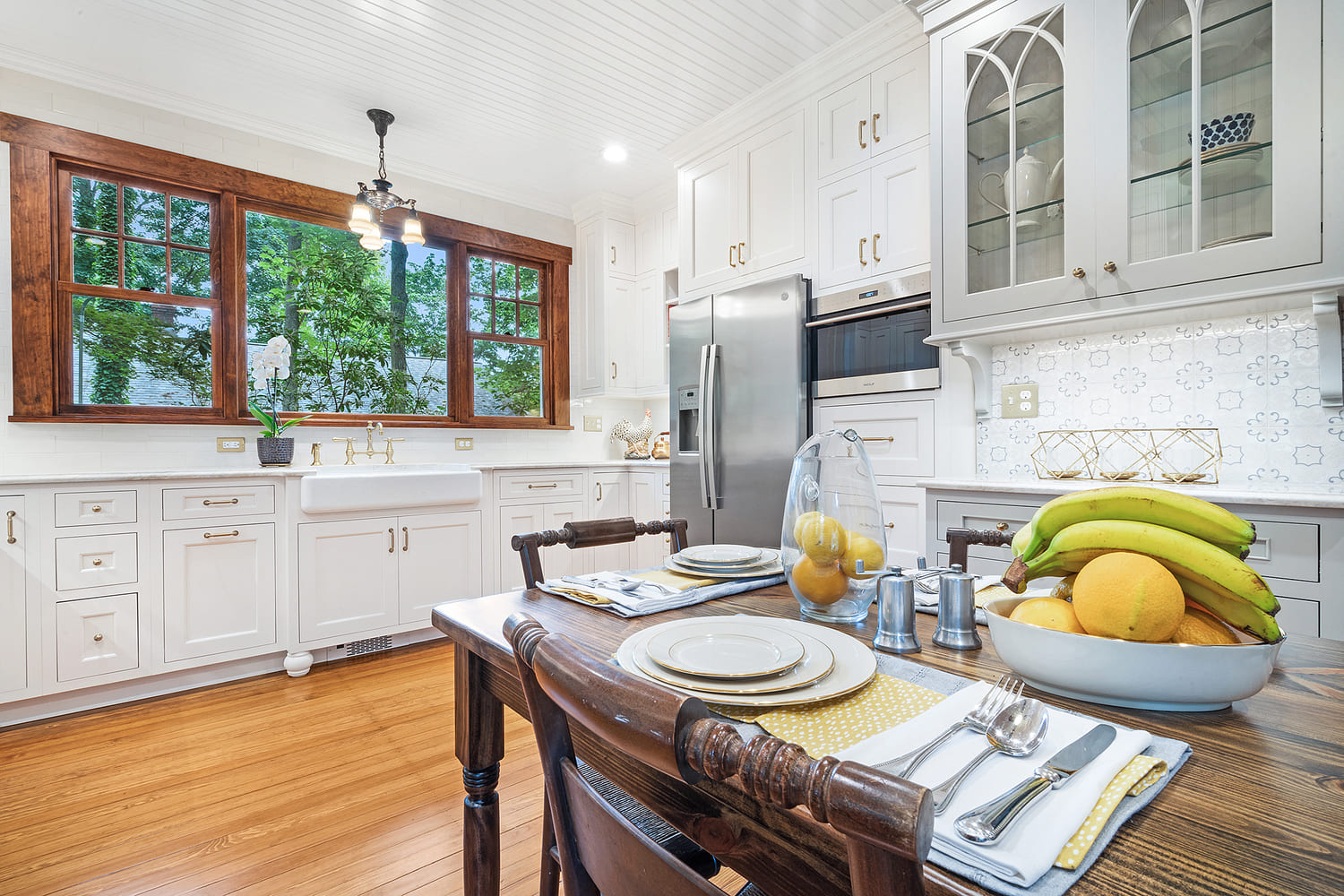 U shaped kitchen remodel with maple painted cabinets in snail and TC Platinum, gold faucets, honey bronze pulls and refinished wood floors remodeled in Butler, NJ by JMC Home Improvement Specialists